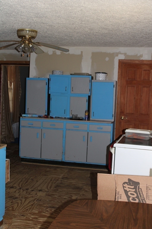 25 Quinebaug Road Dudley, MA 01571 - Photo 15 of 38 a kitchen with a refrigerator and microwave