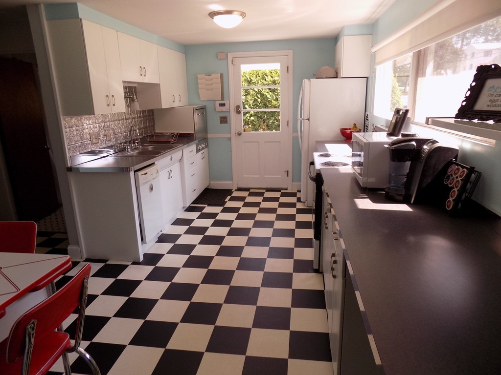 46 Audley Road Springfield, MA 01118 - Photo 8 of 14 a kitchen with a checkered floor and a stove top oven