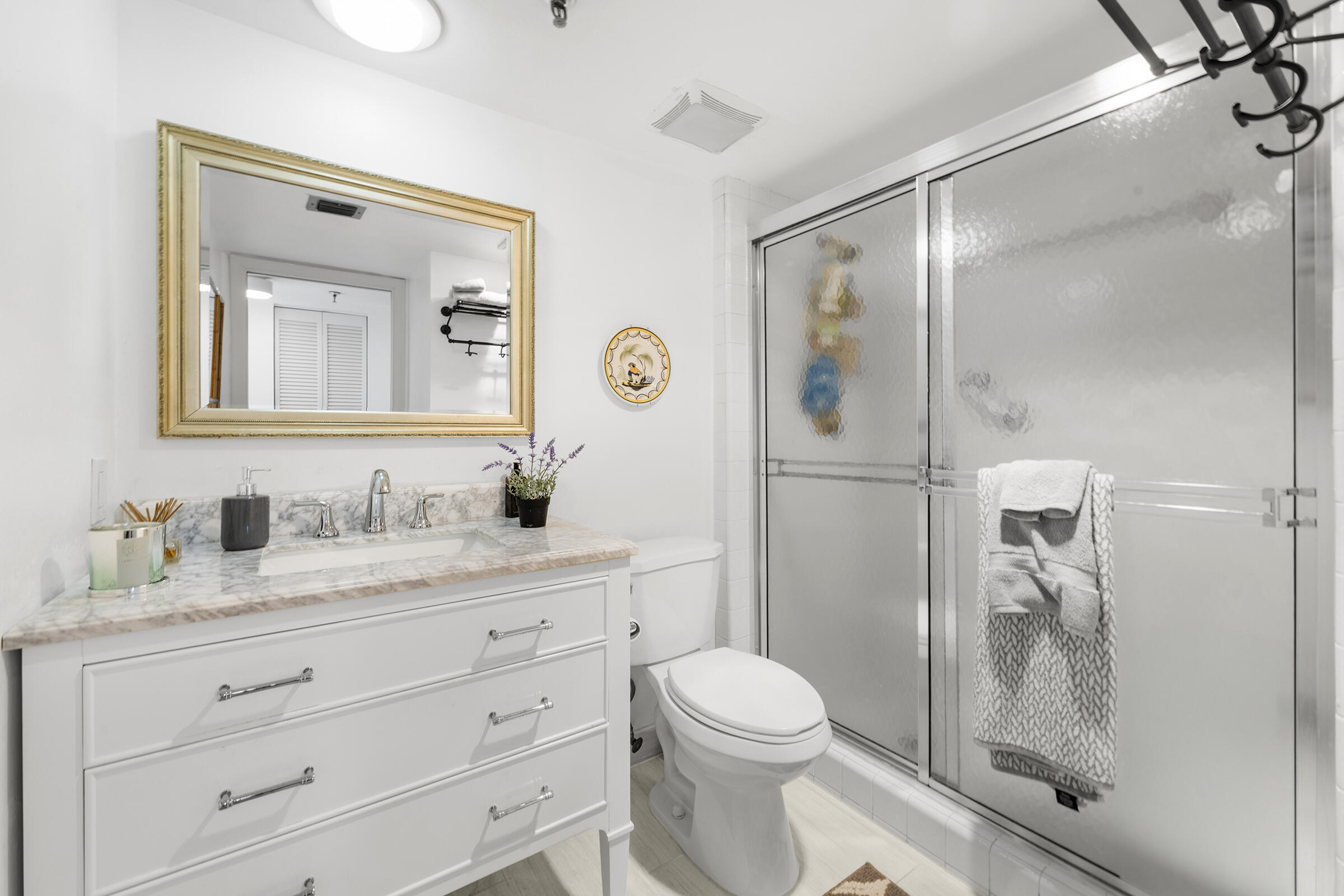 6845 Willow Wood Drive, Unit 3012 Boca Raton, FL 33434 - Photo 19 of 28 a bathroom with a granite countertop sink toilet and shower