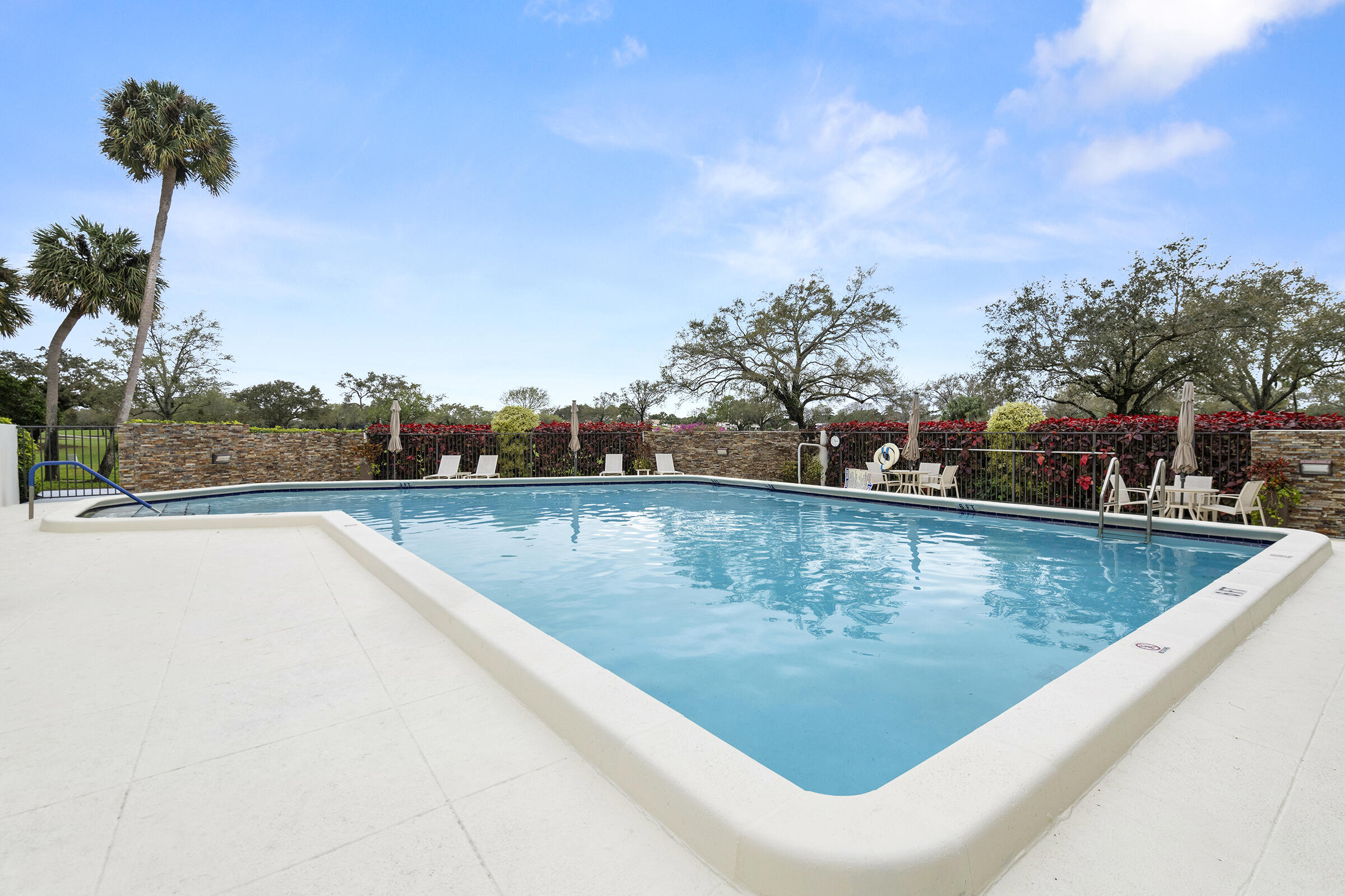 6845 Willow Wood Drive, Unit 3012 Boca Raton, FL 33434 - Photo 25 of 28 a view of a swimming pool and a yard