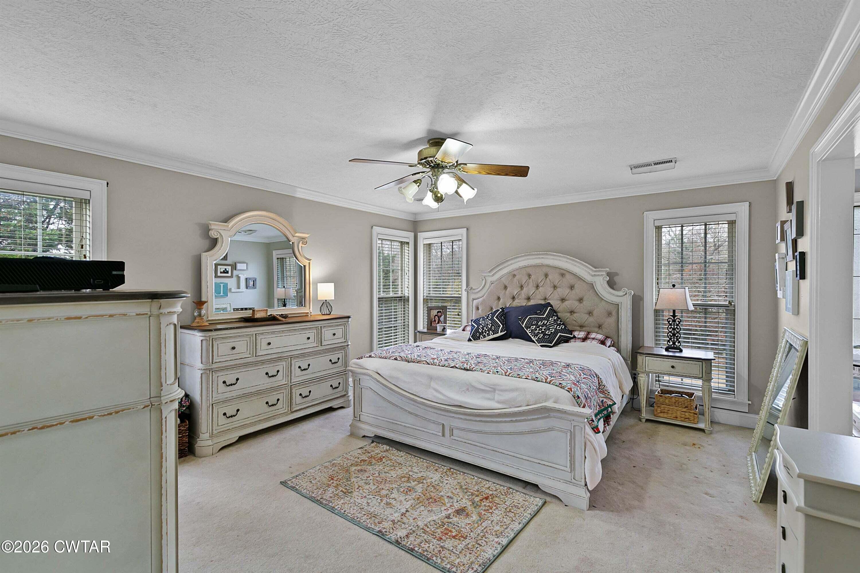 255 Oak Ridge Drive Henderson, TN 38340 - Photo 13 of 23 a bedroom with a bed and a chandelier