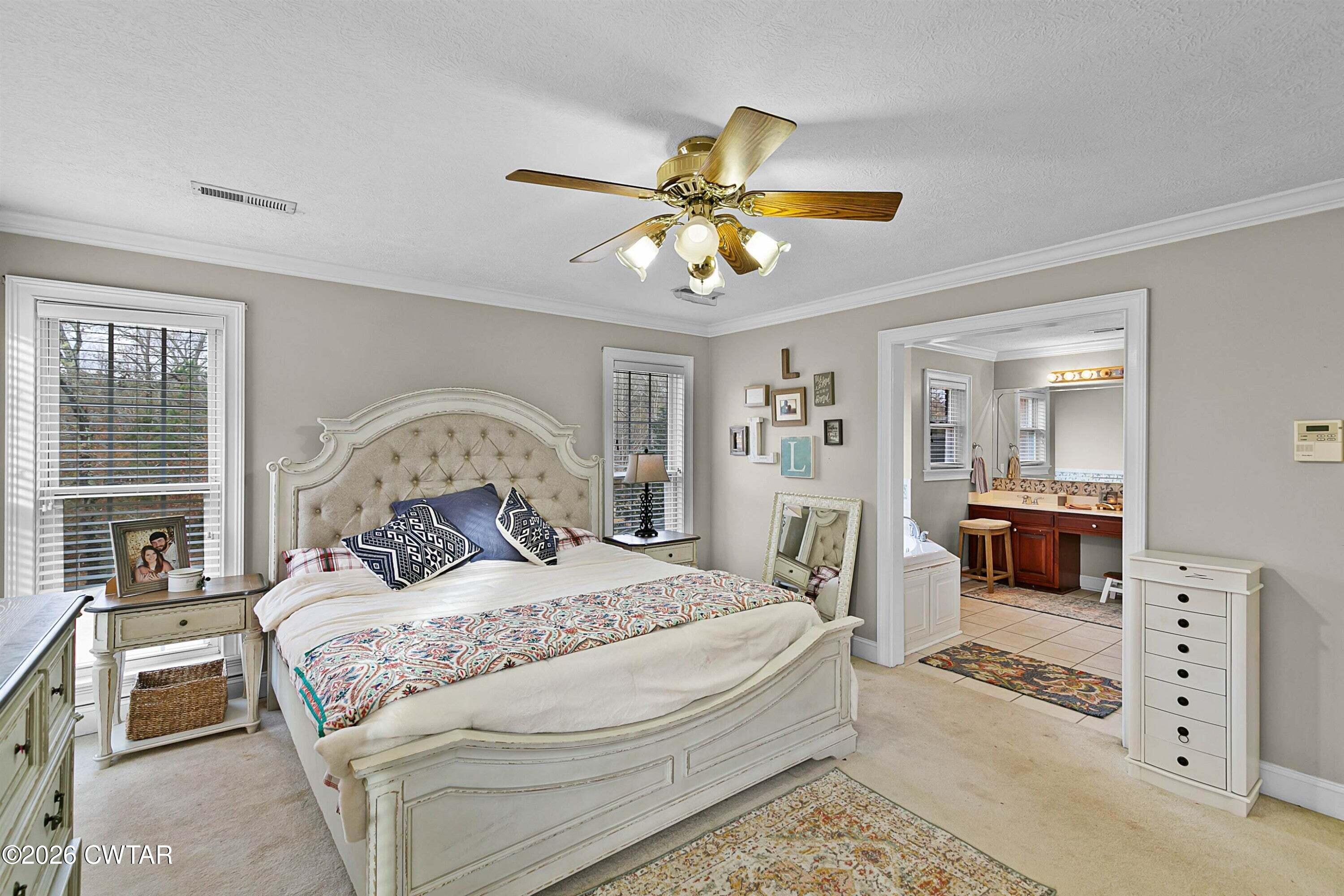 255 Oak Ridge Drive Henderson, TN 38340 - Photo 14 of 23 a bedroom with a bed and a chandelier