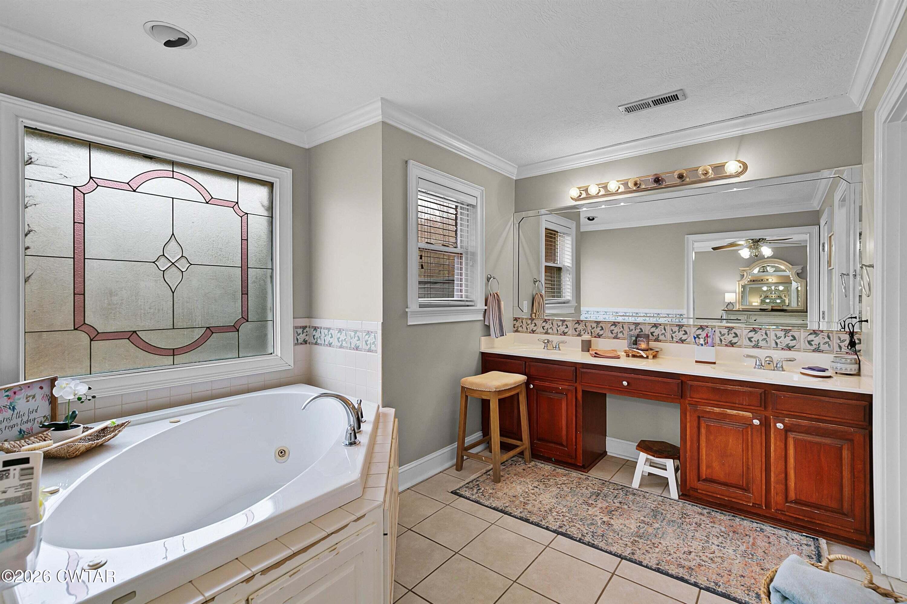 255 Oak Ridge Drive Henderson, TN 38340 - Photo 15 of 23 a bathroom with a tub sink and mirror