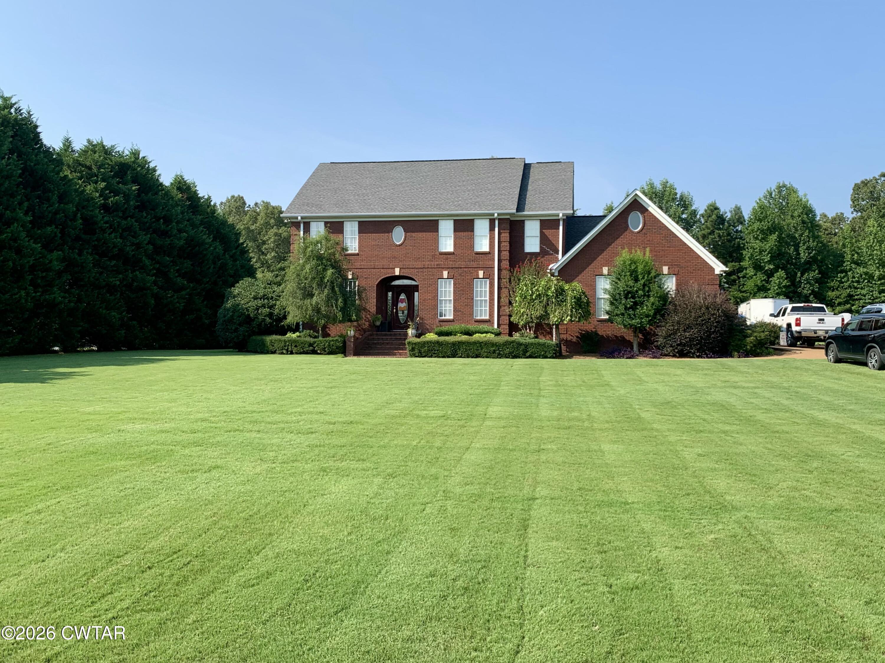 255 Oak Ridge Drive Henderson, TN 38340 - Photo 2 of 23 a front view of a house with garden