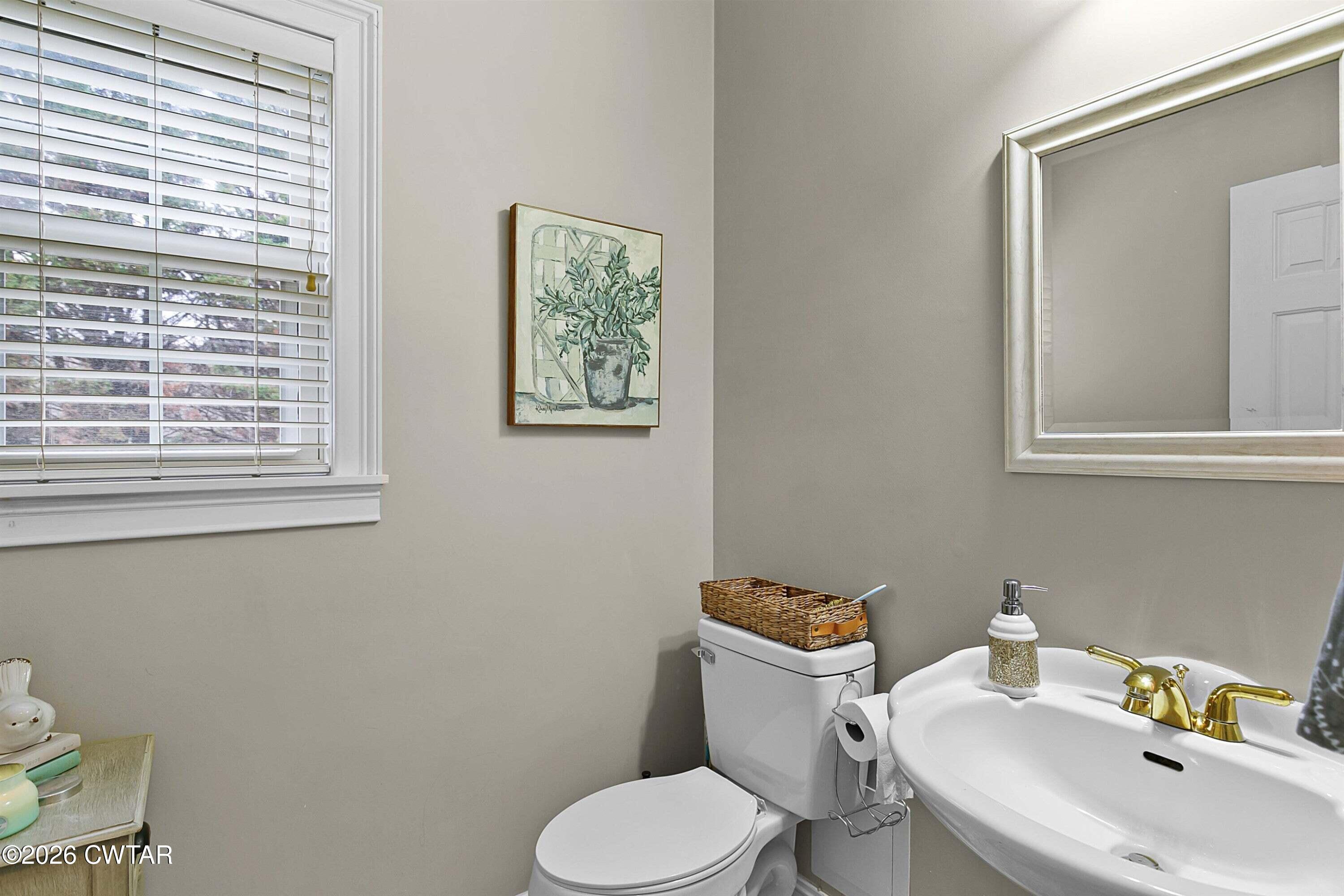 255 Oak Ridge Drive Henderson, TN 38340 - Photo 22 of 23 a white toilet sitting next to a bathroom sink