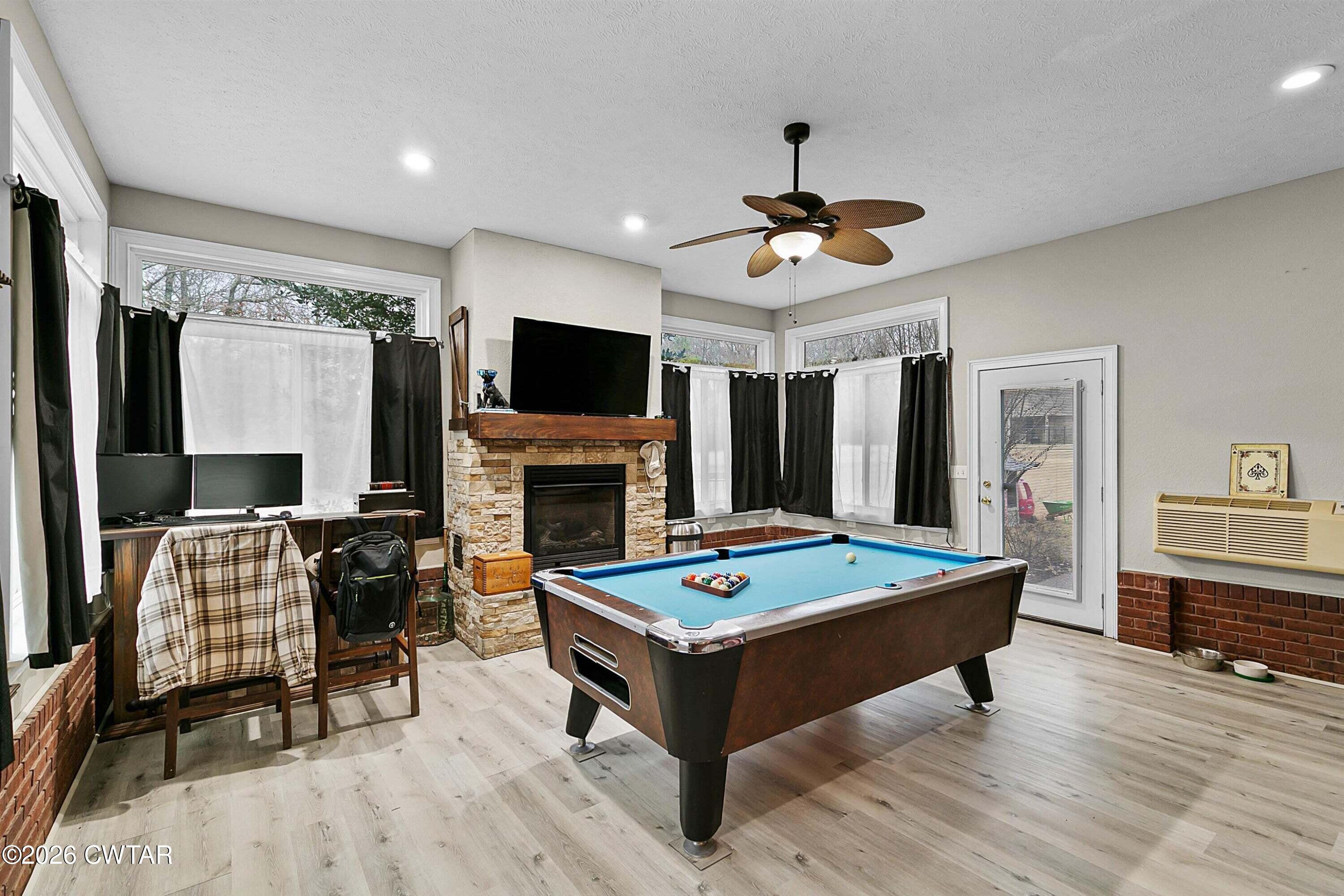 255 Oak Ridge Drive Henderson, TN 38340 - Photo 23 of 23 a living room with a flat screen tv and a fireplace