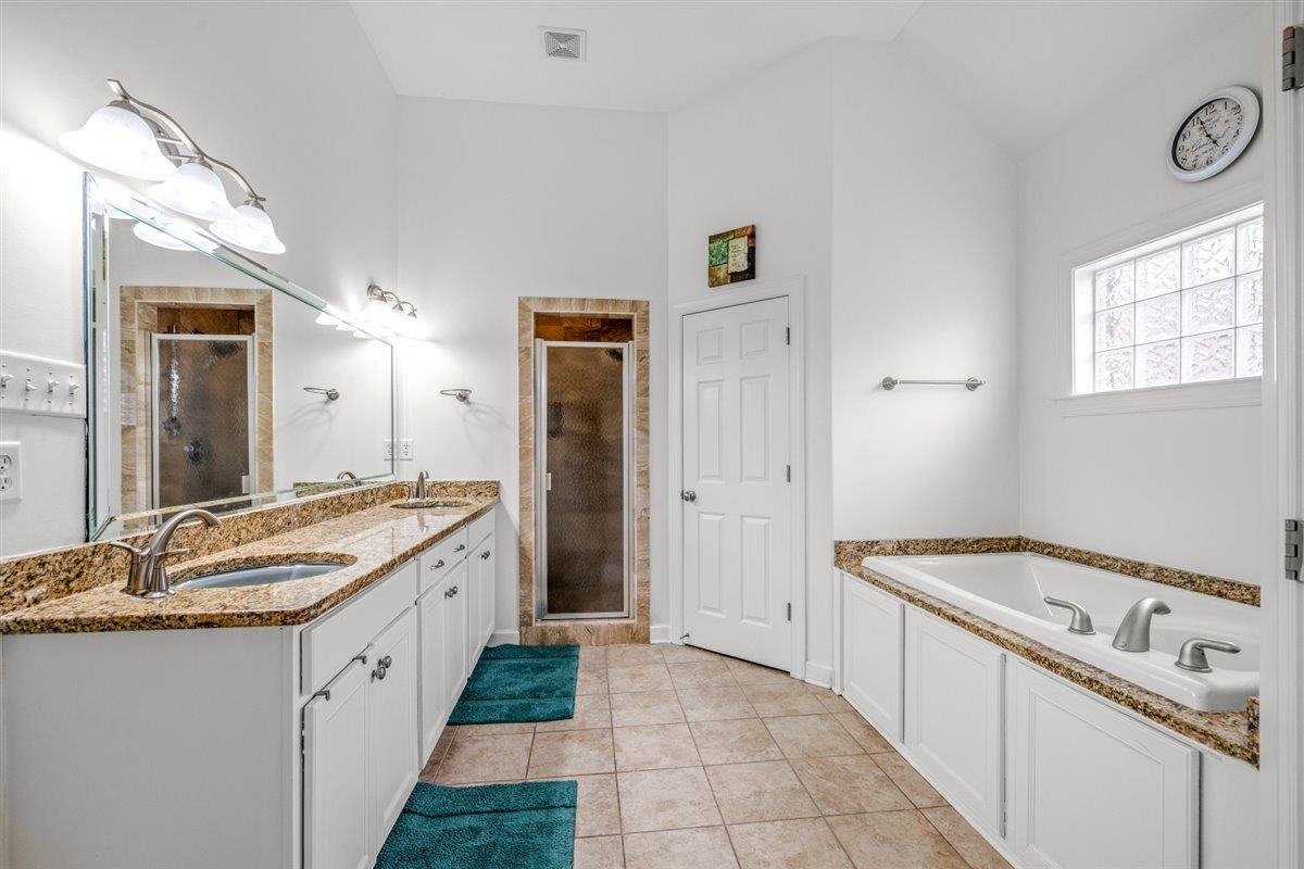 744 Southern Home Road Collierville, TN 38017 - Photo 9 of 24 Bathroom featuring a double vanity with granite countertops, dual vessel sinks, and brushed nickel fixtures