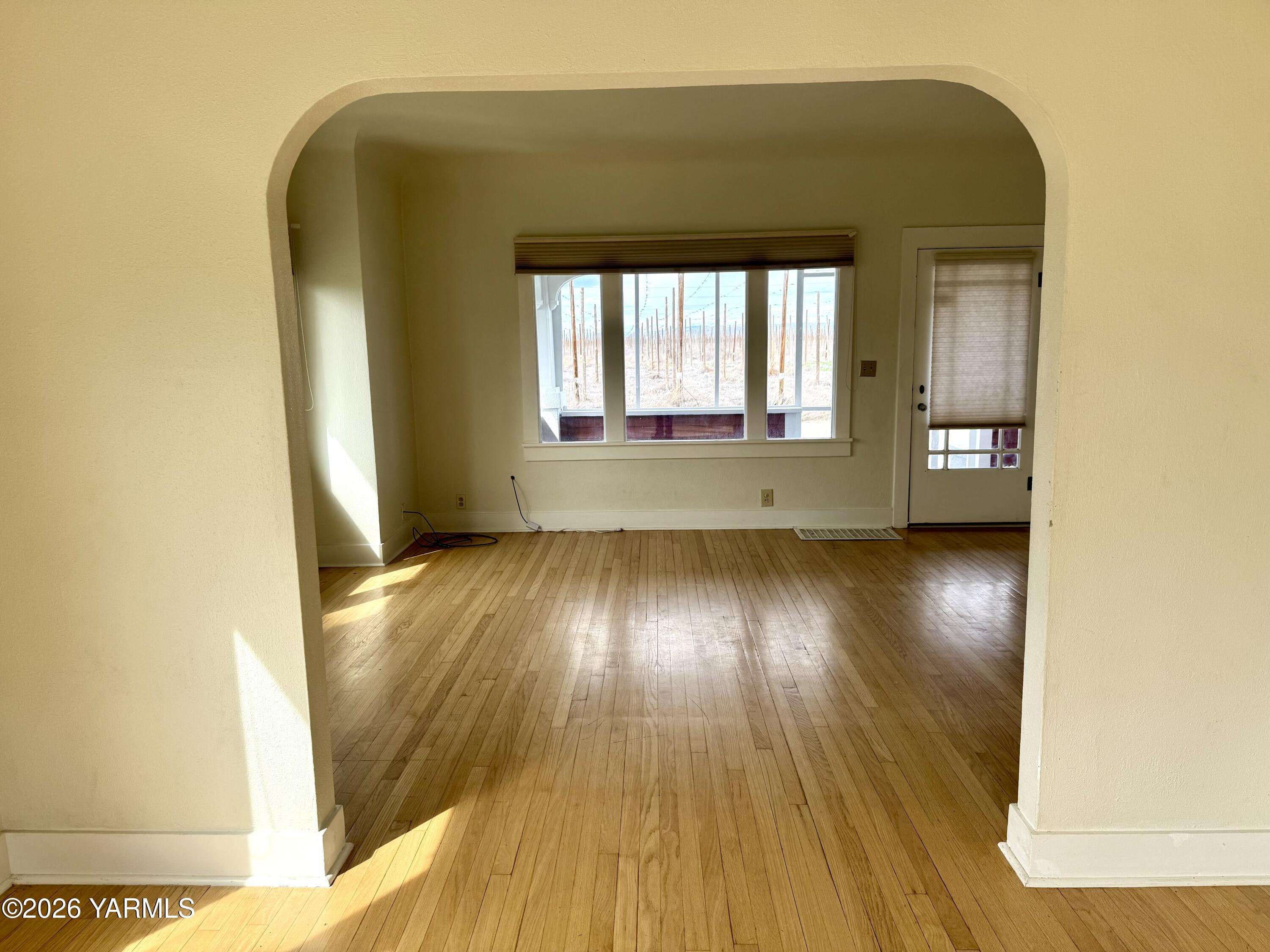 7801 Campbell Road, Unit 1 Toppenish, WA 98948 - Photo 8 of 46 a view of empty room with wooden floor