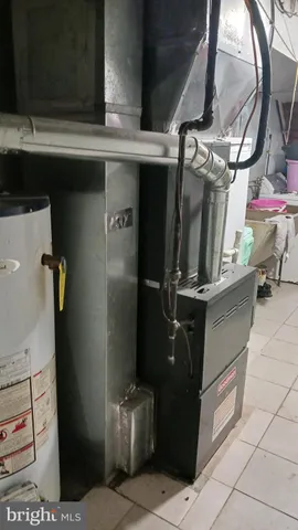 a kitchen with granite countertop a refrigerator and a stove top oven