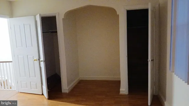 an empty room with wooden floor