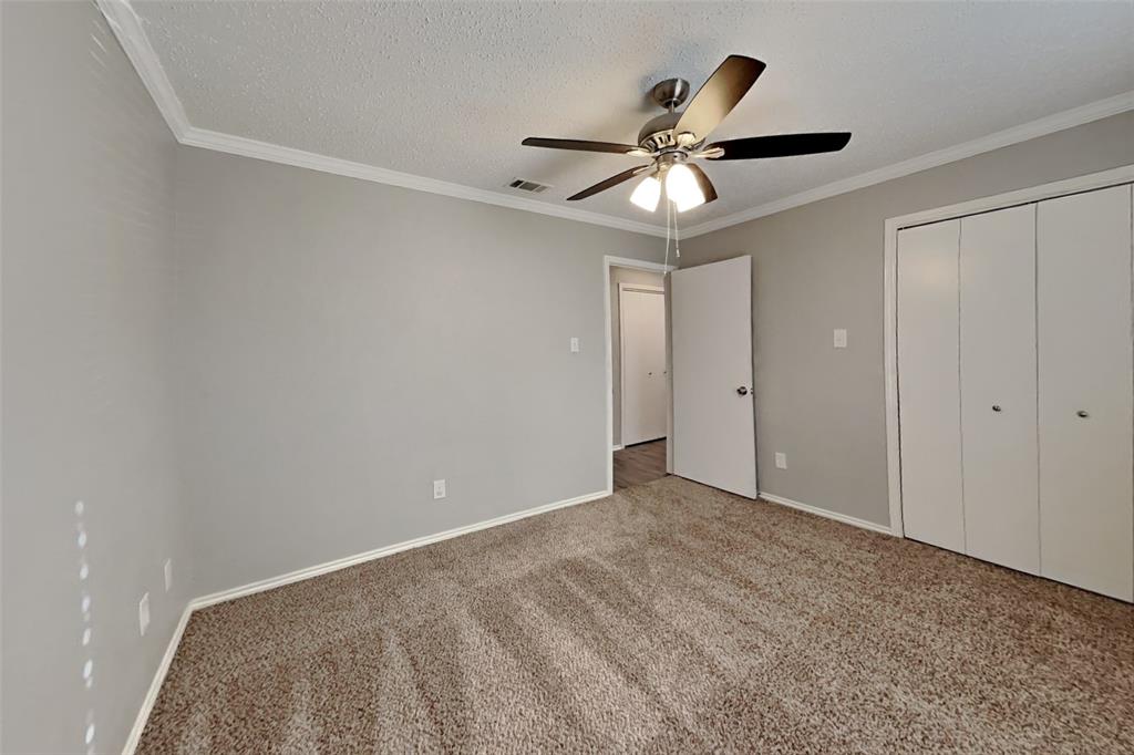 5217 Hollow Bend Lane Garland, TX 75043 - Photo 13 of 18 a view of an empty room with wooden floor and fan