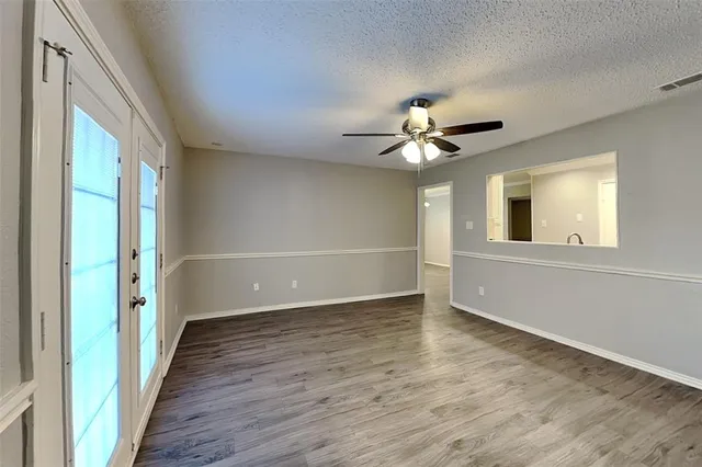 a view of a livingroom with a ceiling fan and wooden floor