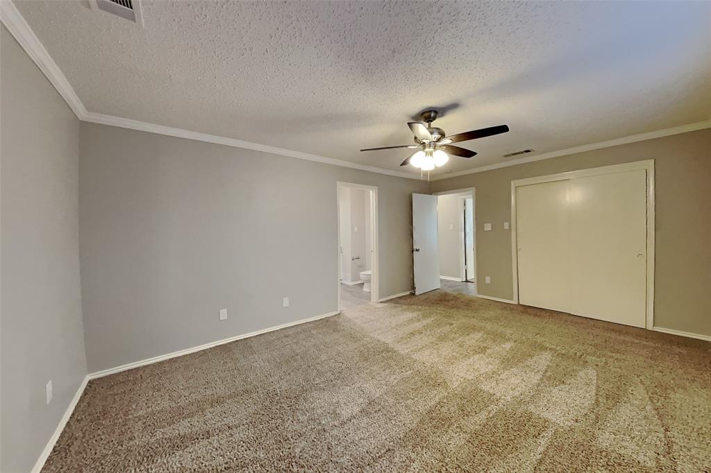 5217 Hollow Bend Lane Garland, TX 75043 - Photo 9 of 18 a view of an empty room with a ceiling fan