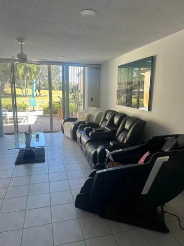 a view of a living room and floor to ceiling window
