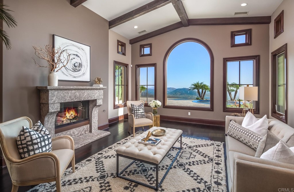 937 Pearl Drive San Marcos, CA 92078 - Photo 27 of 54 a living room with furniture a rug a fireplace and a large window