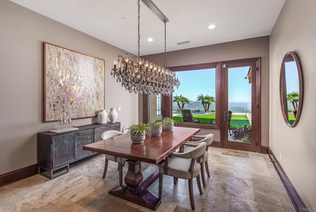 937 Pearl Drive San Marcos, CA 92078 - Photo 37 of 54 a dining room with furniture a large window and a chandelier