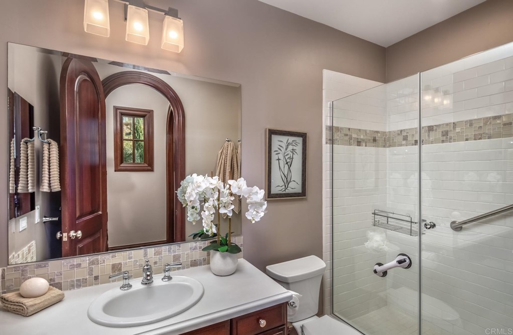 937 Pearl Drive San Marcos, CA 92078 - Photo 40 of 54 a bathroom with a granite countertop sink a toilet and a mirror