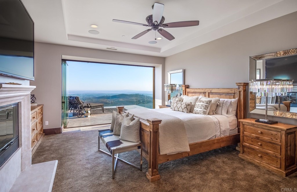 937 Pearl Drive San Marcos, CA 92078 - Photo 46 of 54 a bedroom with a bed and a fireplace