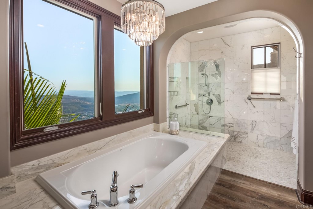 937 Pearl Drive San Marcos, CA 92078 - Photo 48 of 54 a bathroom with a tub a sink and a large mirror