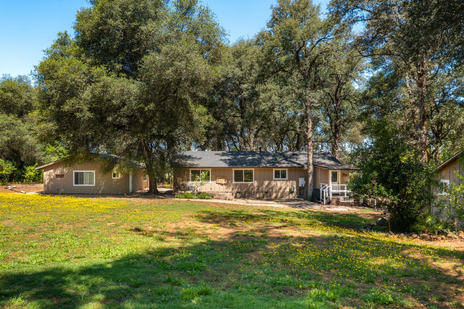 10875 Spenceville Road Penn Valley, CA 95946 - Photo 26 of 49 a front view of a house with a yard table and chairs