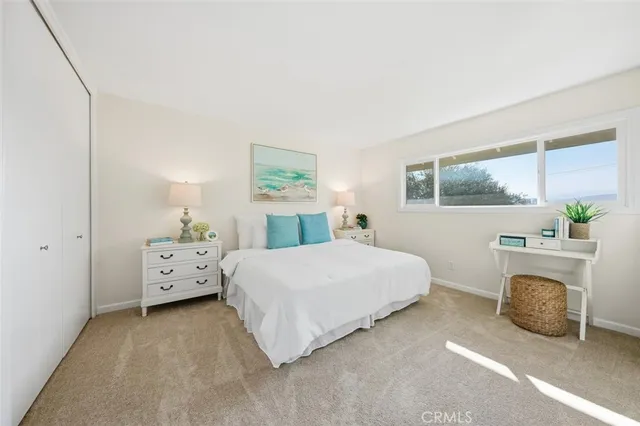 a spacious bedroom with a bed and a window