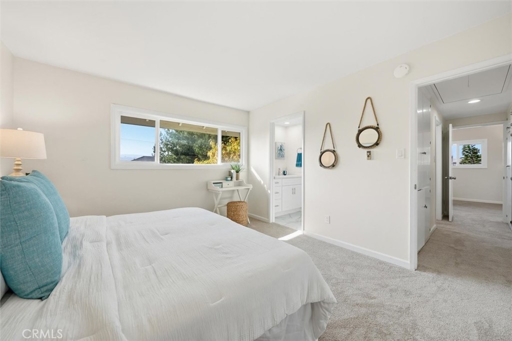 23005 Nadine Circle, Unit B Torrance, CA 90505 - Photo 14 of 29 a bedroom with a large bed and a chandelier