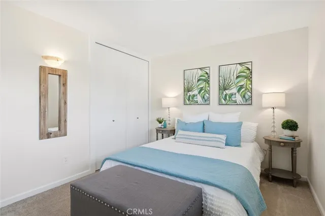 a bedroom with a bed and a painting on the wall