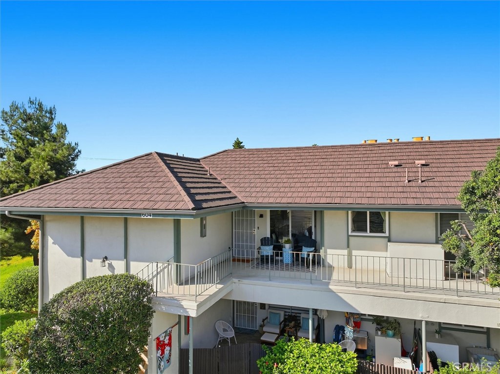 23005 Nadine Circle, Unit B Torrance, CA 90505 - Photo 29 of 29 a view of a white house with large windows and a table and chairs