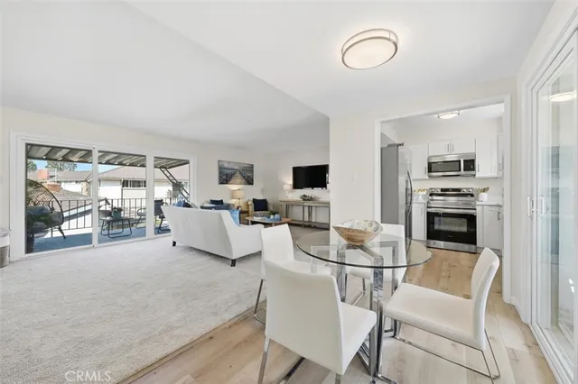 a living room with furniture a flat screen tv and a table