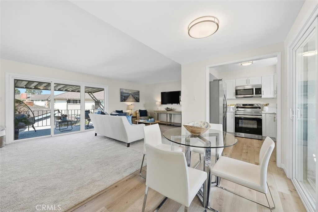 23005 Nadine Circle, Unit B Torrance, CA 90505 - Photo 5 of 29 a living room with furniture a flat screen tv and a table