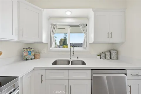 a kitchen with sink and cabinets