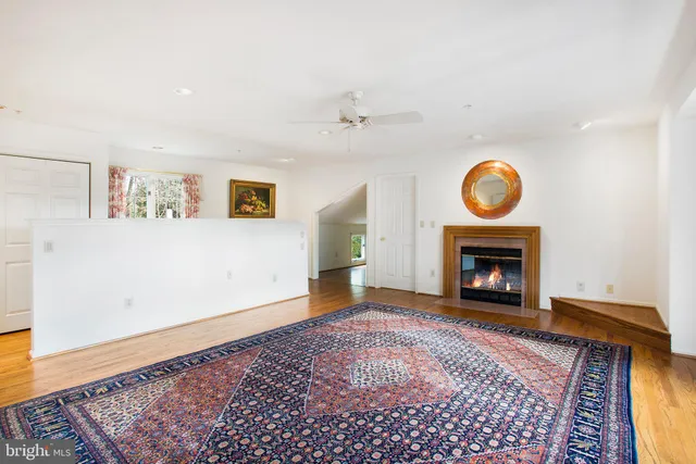 a kitchen with stainless steel appliances granite countertop a sink a stove and wooden floors
