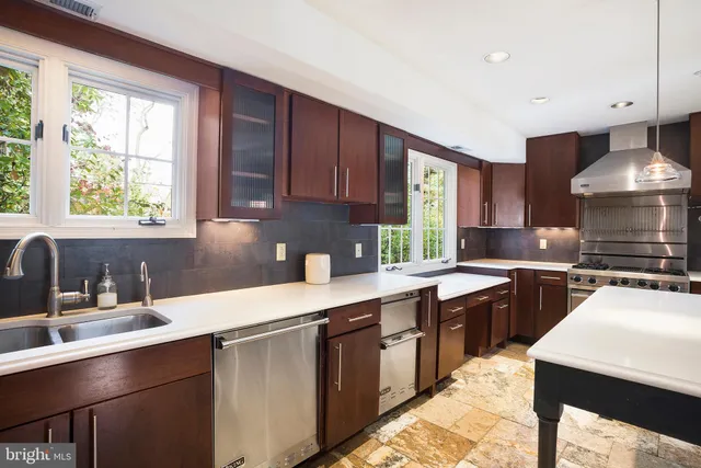 a kitchen with a stove sink and cabinets