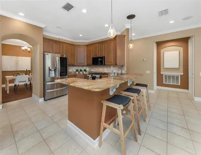 a spacious bathroom with a double vanity sink a large mirror and a bathtub