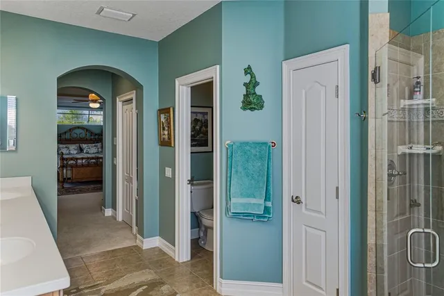 a view of a ocean with boats and trees in the background
