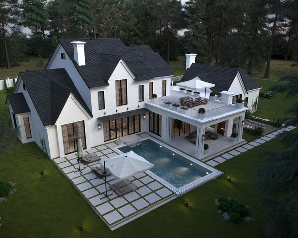 a aerial view of a house next to a big yard with plants and large trees