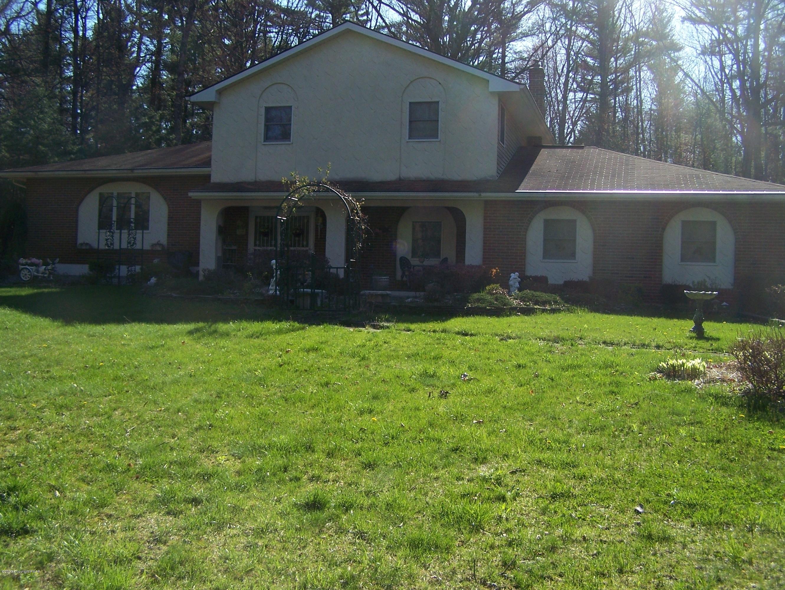 557 Long Mountain Road Effort, PA 18330 - Photo 1 of 45 a front view of house with yard and green space