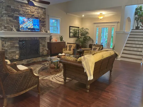 a living room with furniture a flat screen tv and a fireplace