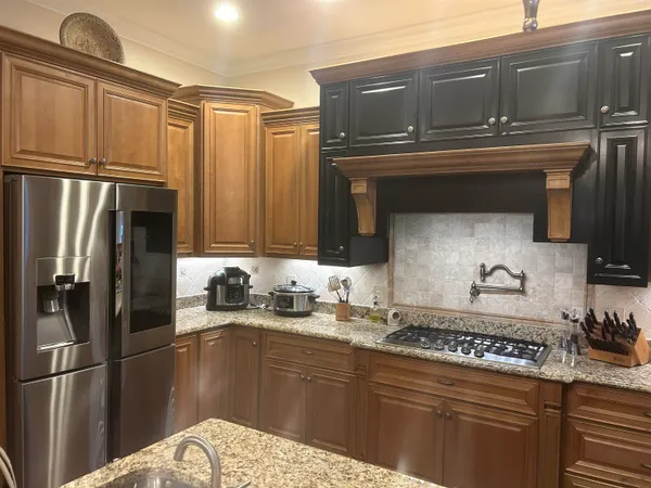a kitchen with stainless steel appliances a sink stove and refrigerator