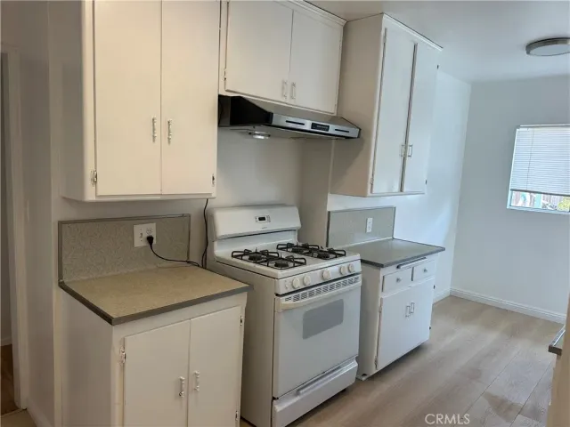 a kitchen with a stove and a sink