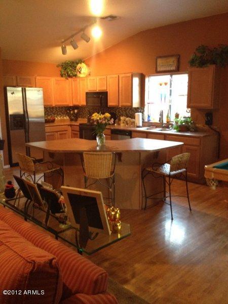 4132 East Chambers Street Phoenix, AZ 85040 - Photo 5 of 16 a room with table chairs and a potted plant