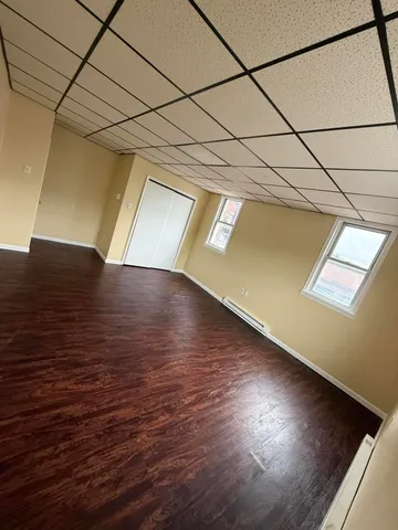 a view of a room with wooden floor and brick walls