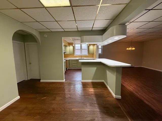 a view of entryway with kitchen island dining table and chairs