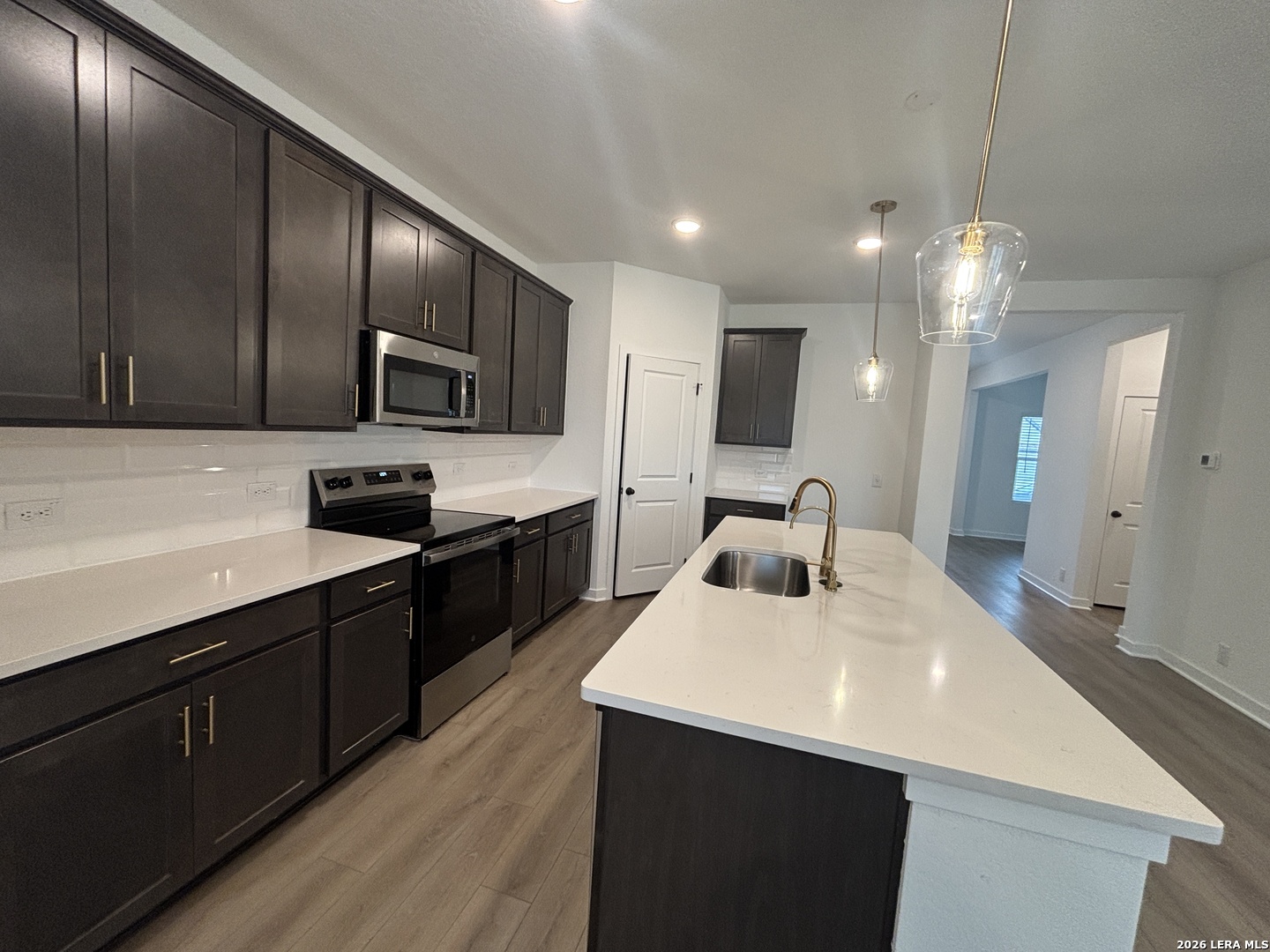10101 Peppercorn Place Schertz, TX 78154 - Photo 11 of 36 a kitchen with kitchen island granite countertop stainless steel appliances cabinets a sink and a counter top space