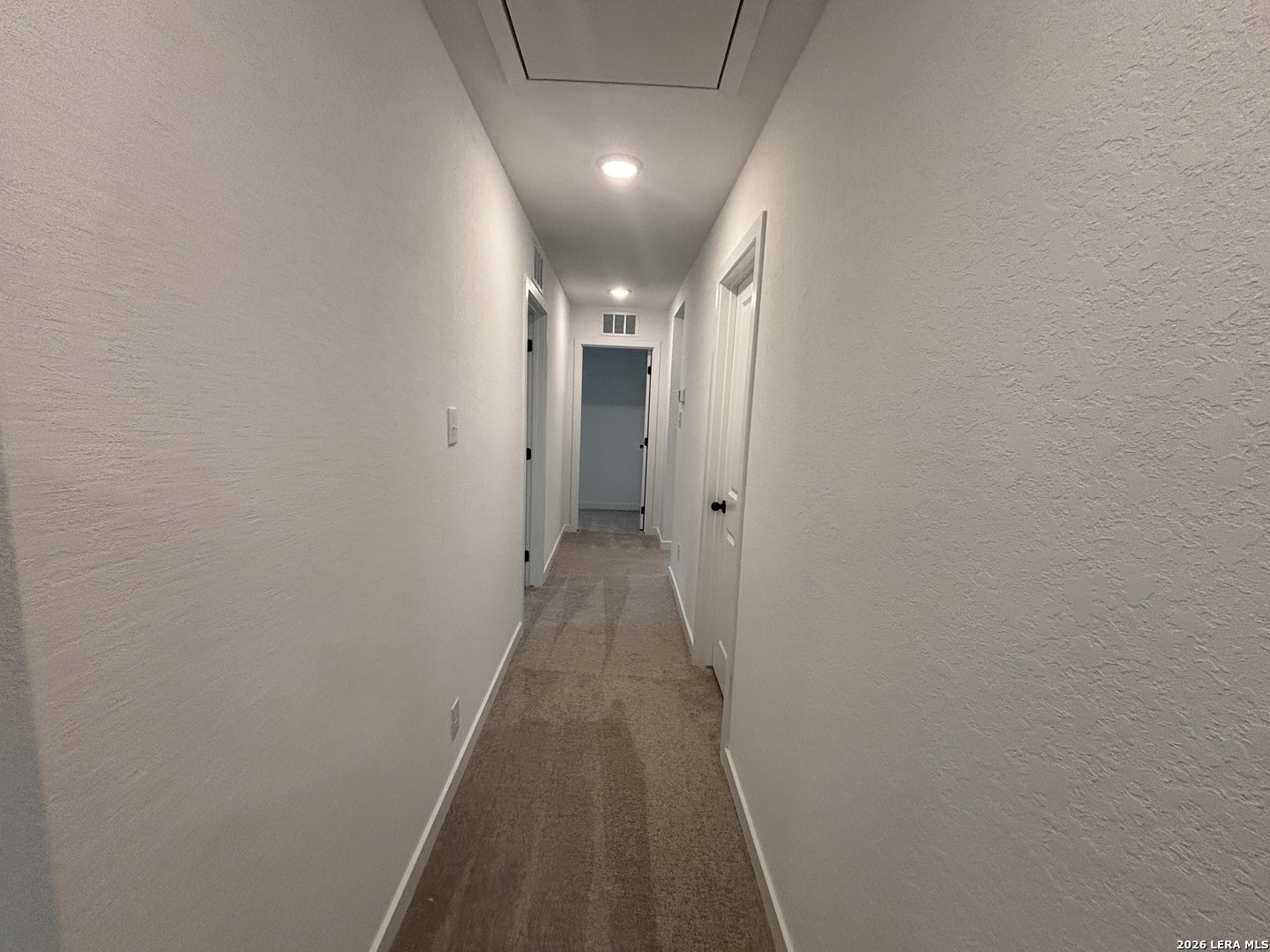 10101 Peppercorn Place Schertz, TX 78154 - Photo 21 of 36 a view of a hallway with wooden floor and chandelier