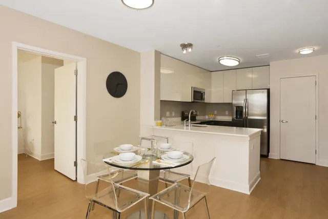 a kitchen with stainless steel appliances granite countertop a refrigerator and a sink
