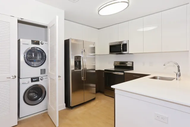 a kitchen with a refrigerator sink and a stove top oven