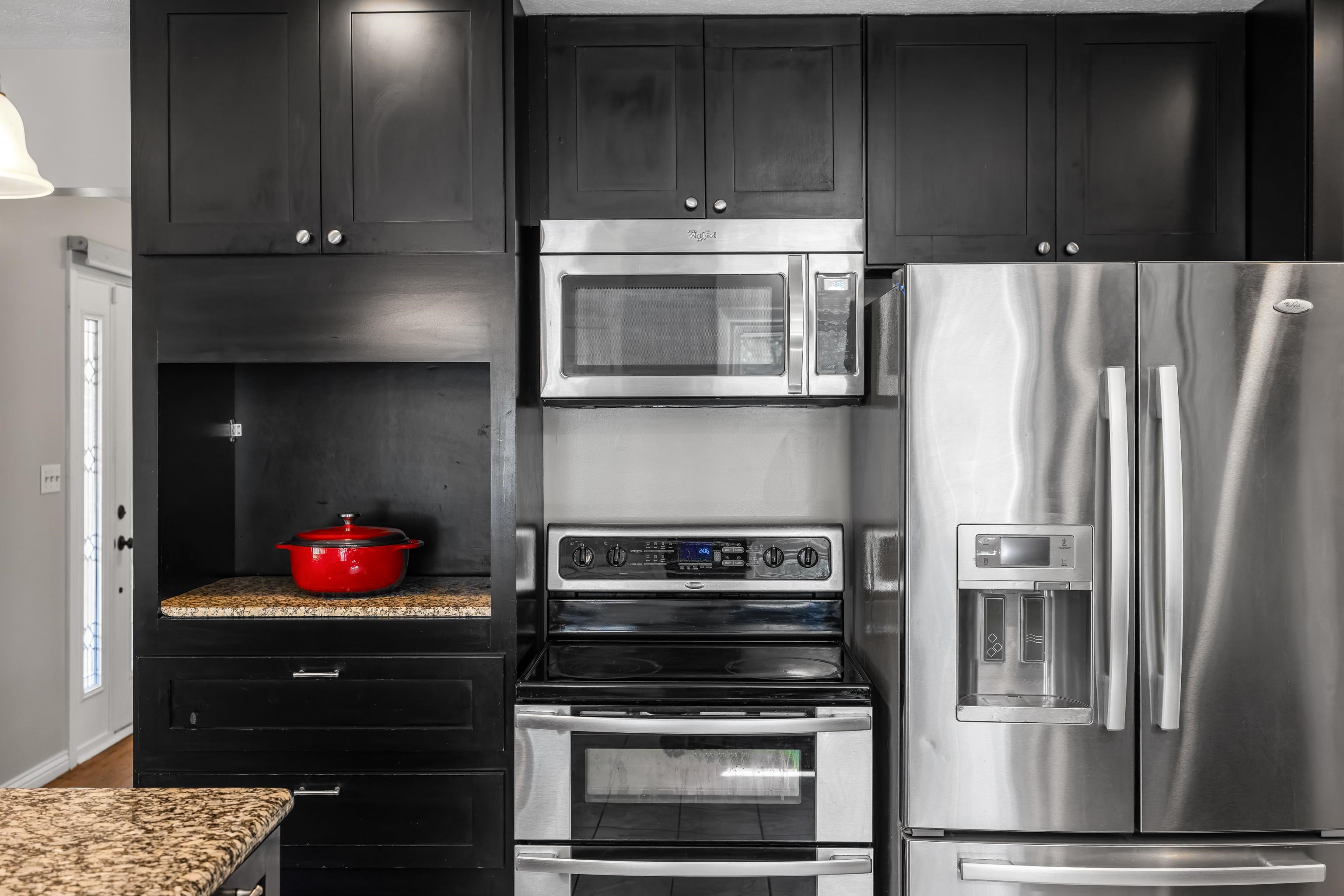 249 Cattle Scales Road Waynesboro, VA 22980 - Photo 21 of 50 a kitchen with granite countertop wooden cabinets and stainless steel appliances