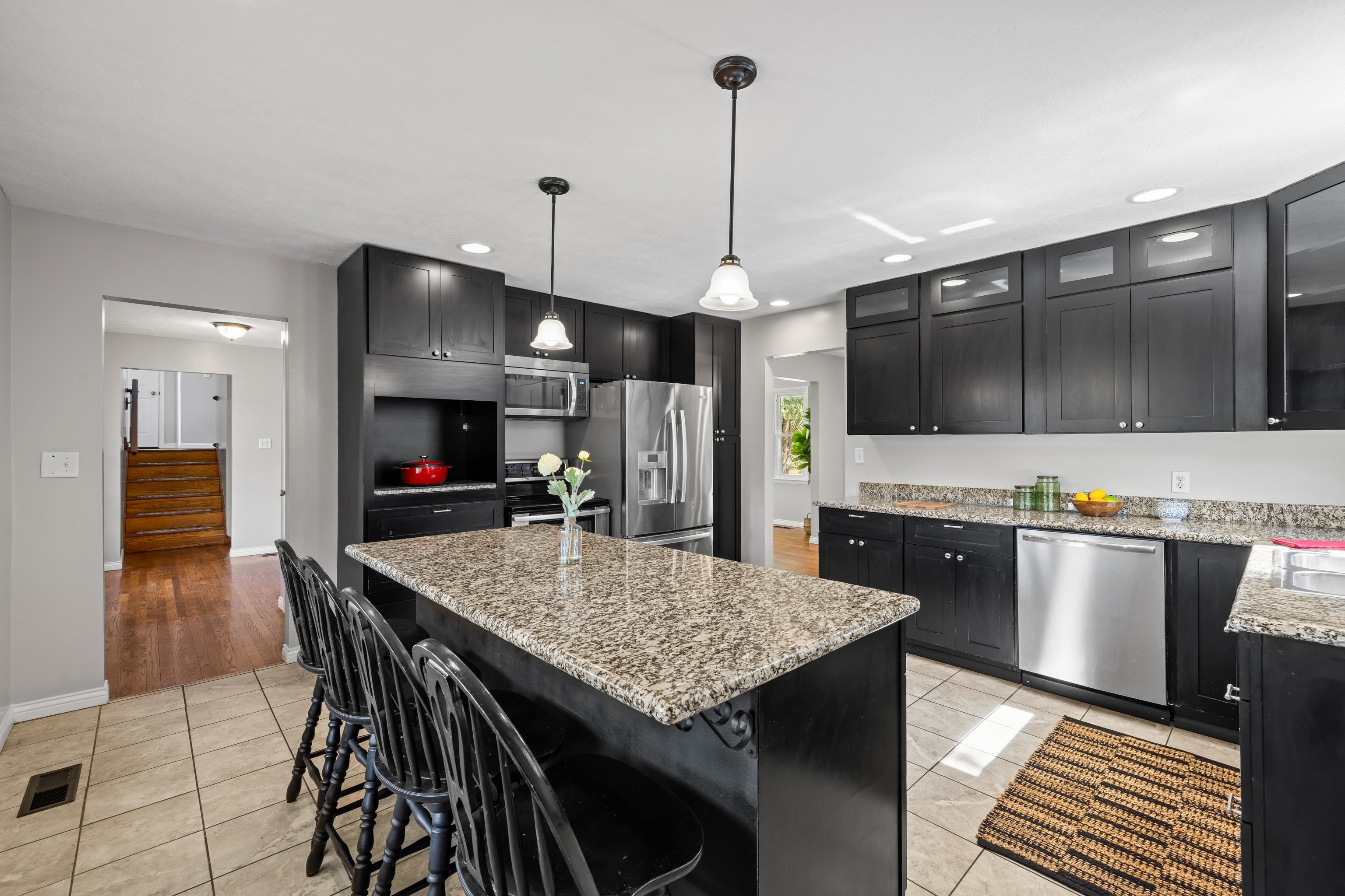 249 Cattle Scales Road Waynesboro, VA 22980 - Photo 24 of 50 a kitchen with stainless steel appliances kitchen island granite countertop a table chairs in it and wooden floors