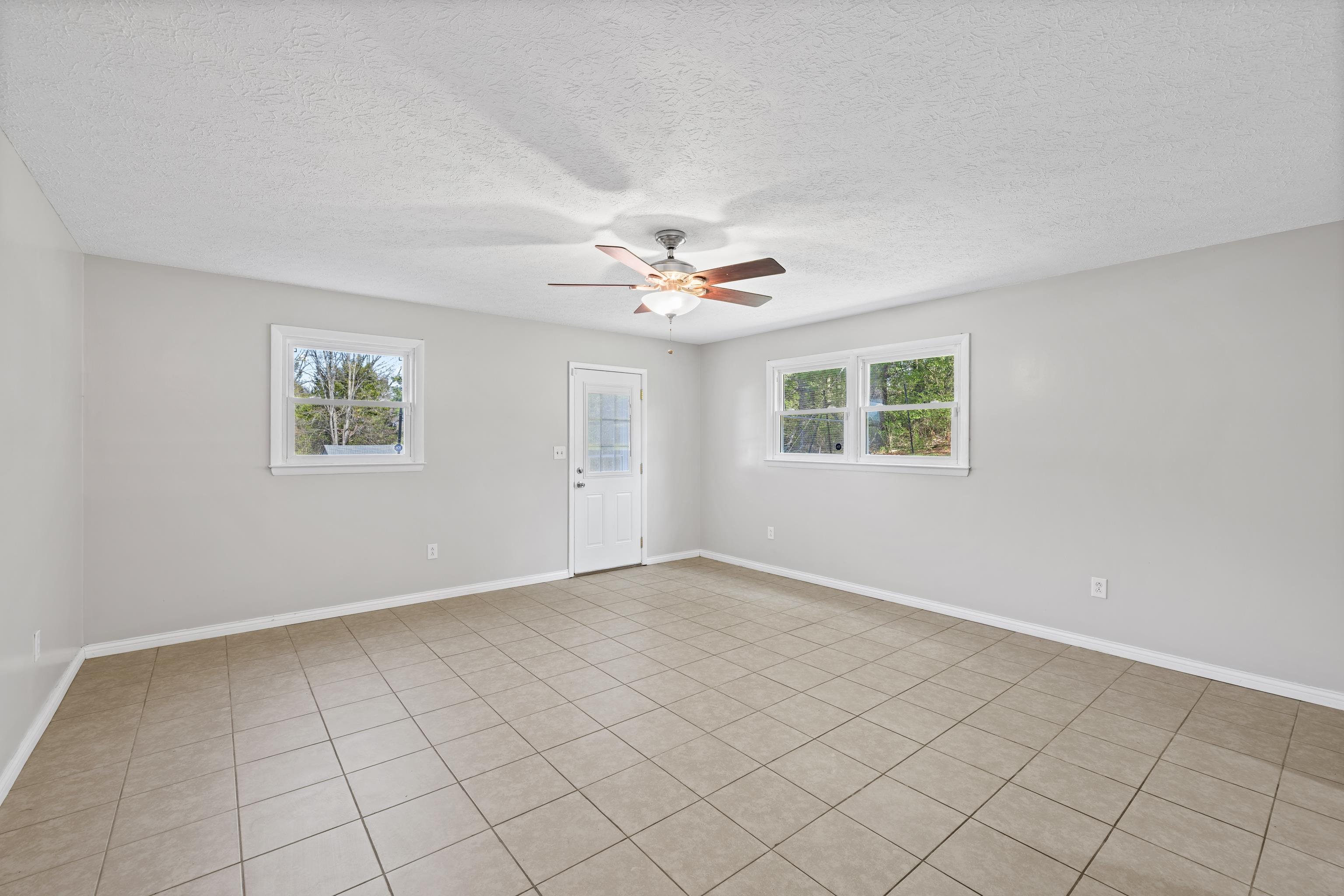 249 Cattle Scales Road Waynesboro, VA 22980 - Photo 35 of 50 an empty room with windows and ceiling fan